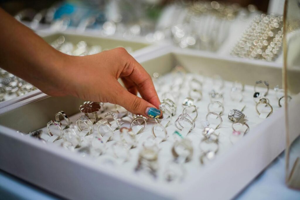 Female hand picks a ring at a jewelry store. Stock photo.