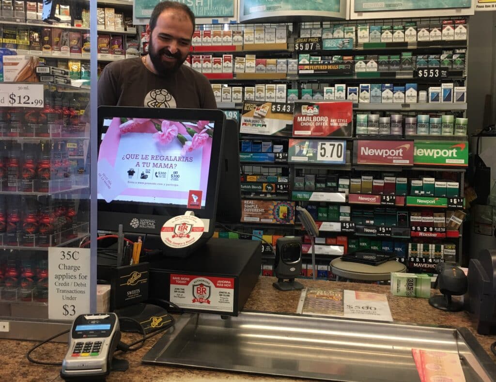 Retail POS system at Tobacco Shop with customer-facing screen, barcode reader, cash drawer and a card reader. Photo by NRS.