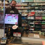 Retail POS system at Tobacco Shop with customer-facing screen, barcode reader, cash drawer and a card reader.