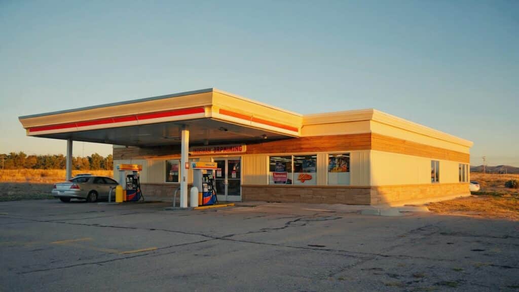 NRS Petro POS terminal at a gas station checkout with the fuel forecourt visible behind