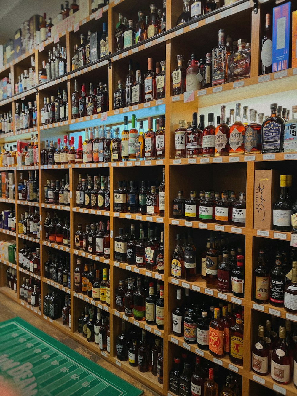 A liquor store with shelves packed with various brands of whiskey and bourbon bottles