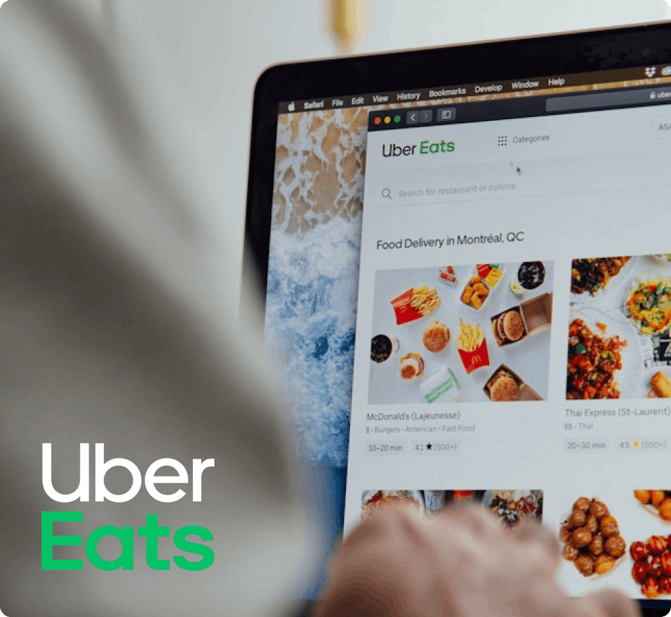 A person browsing Uber Eats on a laptop, showing food delivery options in Montr&eacute;al, QC